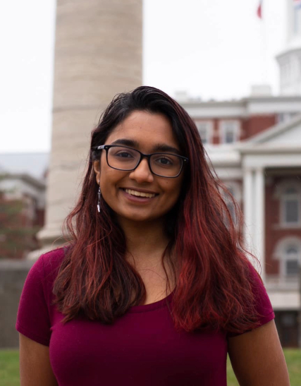 Arya Kalathil stands in front of one of the Columns