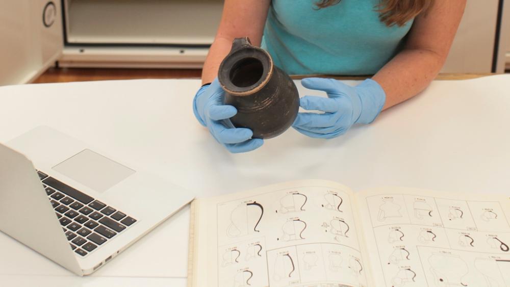 Photo of artifact being handled in museum